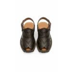Nomad Rugged Tooled Leather Sandals in dark brown with floral stamps and a heavy lug sole on a white background.